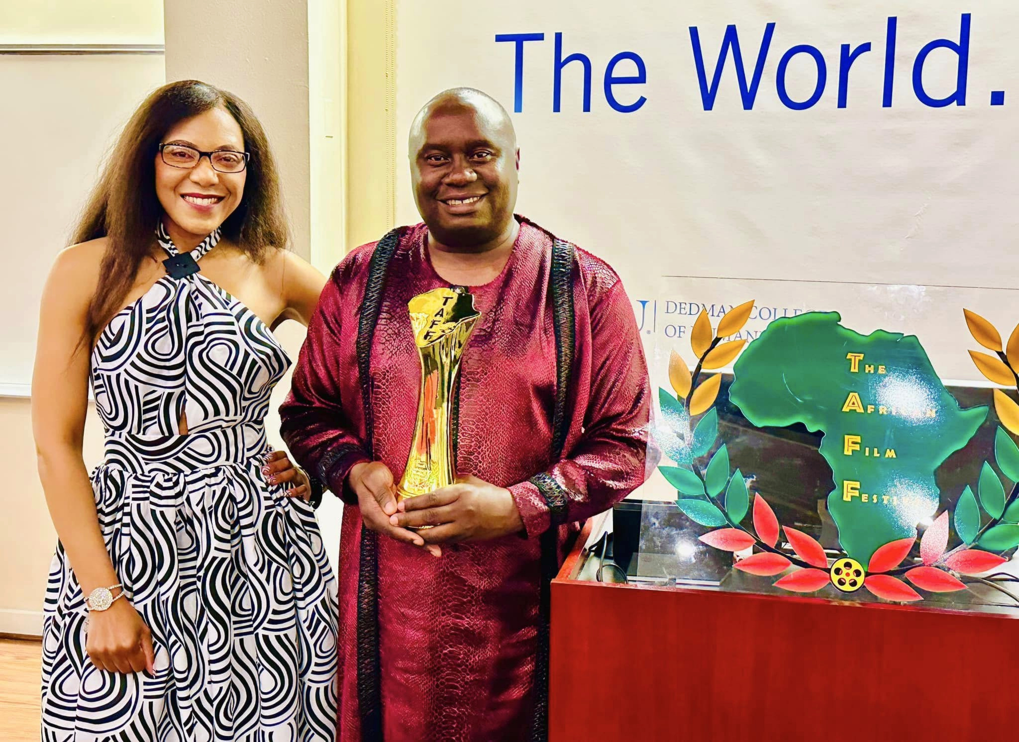 Davies Chirwa at the African Film Festival holding an award